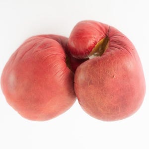 May include: Pair of well-worn, red leather boxing gloves. The gloves are positioned together, with the palms facing inward. The leather shows signs of use, with some discoloration and wear. The gloves are set against a plain white background.