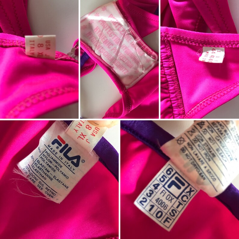 May include: A pink swimsuit with purple trim and a white label that says "FILA" and "MADE IN ITALY". The label also includes the size information "USA J 8 XL ITALY".