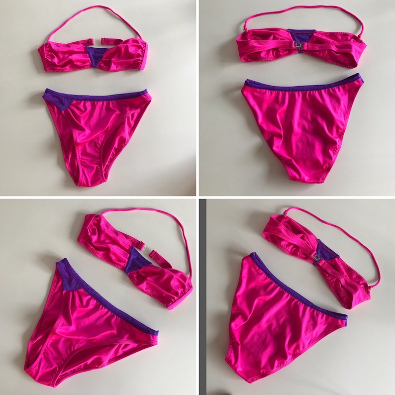 May include: A pink bikini with purple trim. The top is a bandeau style and the bottom is a classic cut.