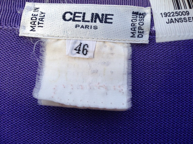 May include: A white tag with black text that reads "CELINE PARIS" and "MADE IN ITALY". A smaller white tag with black text reads "MARQUE DEPOSEE". A white tag with black text reads "46". A white tag with black text reads "19225009 JANSSEN".