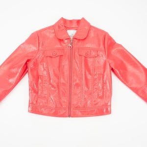 May include: A bright pink faux leather jacket with a zipper closure and two flap pockets. The jacket has a shiny finish.
