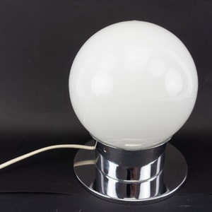 May include: A chrome table lamp with a large white glass globe shade.
