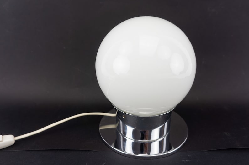 May include: A chrome table lamp with a large white glass globe shade.