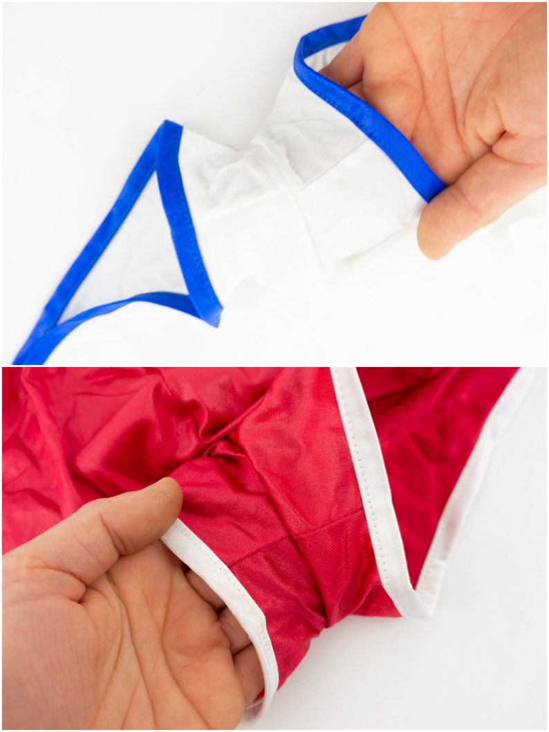 May include: Two pairs of underwear with contrasting trim. One pair is white with blue trim, and the other is red with white trim.