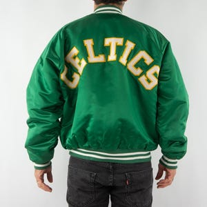 May include: Green satin bomber jacket with a white and yellow "CELTICS" logo on the back.