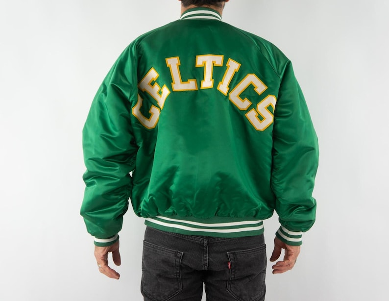 May include: Green satin bomber jacket with a white and yellow "CELTICS" logo on the back.