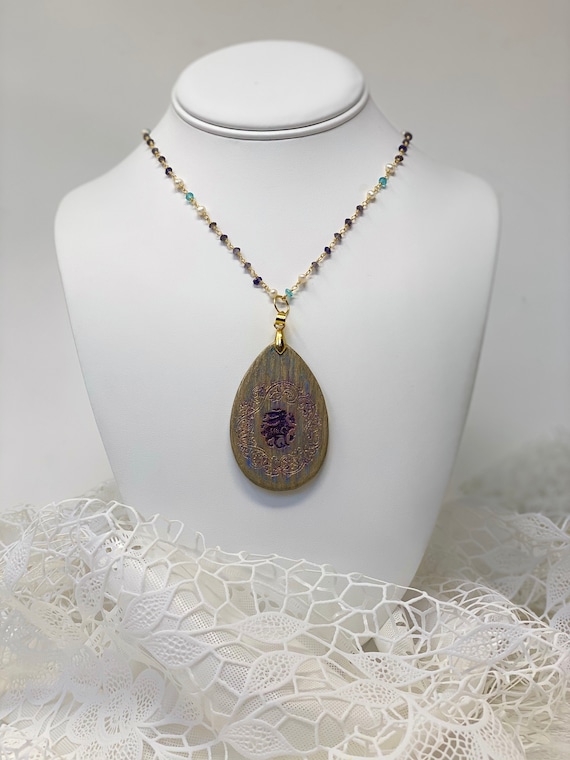 The Arabesque® Wooden Engraved Medieval Bunny Teardrop Pendant with Tanzanite, Aqua Marine, and Pearl 24k Gold Plated Rosary Bead Necklace