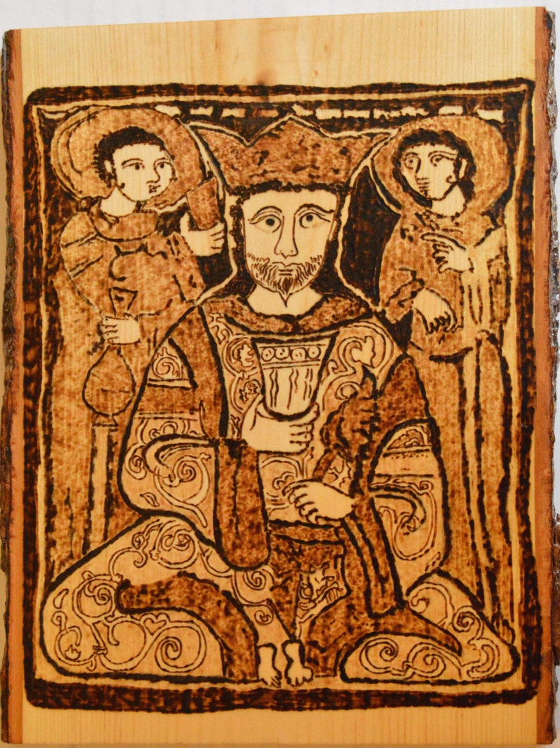 May include: A woodburned image of a king in a crown, seated with two figures standing behind him. The image is in shades of brown and black, with intricate details in the clothing and background.
