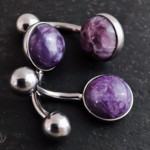 3, 8mm purple charoite cabochon set in a polished 316l steel belly bar on a slate background