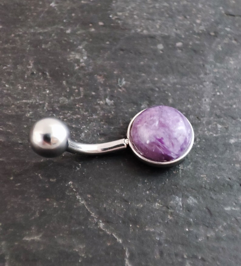 8mm purple charoite cabochon set in a polished 316l steel belly bar on a slate background