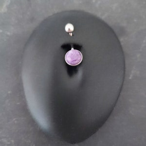 purple charoite belly bar, displayed in a black silicone display belly button piercing