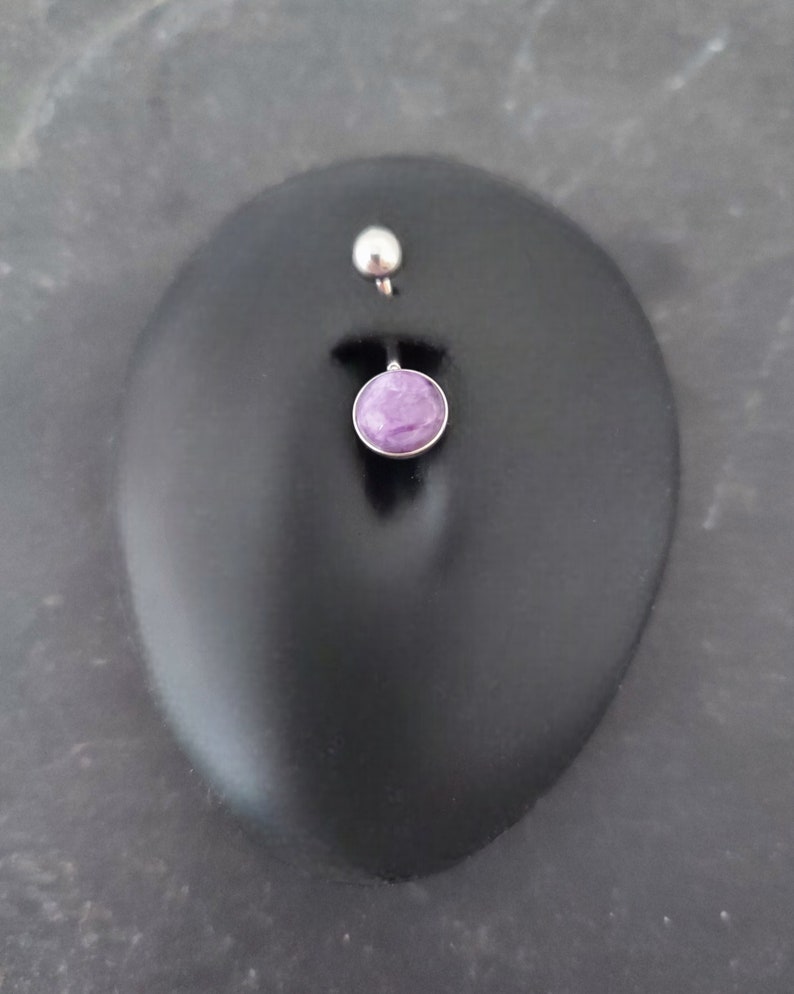 purple charoite belly bar, displayed in a black silicone display belly button piercing