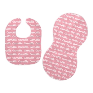 May include: Two pink baby bibs with the name "Camille" repeated in white script.
