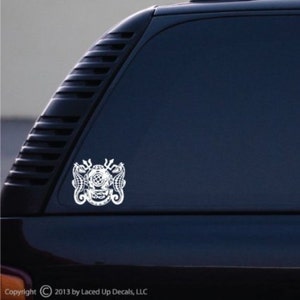 May include: White decal featuring a vintage diving helmet design, flanked by seahorses and tridents. The decal is applied to a dark blue vehicle window. Copyright 2013 by Laced Up Decals, LLC.