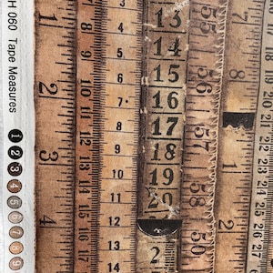 May include: A fabric featuring a repeating pattern of vintage tape measures. The tape measures are in shades of brown and beige, with black numbering and markings. The text "#PWTH 060 Tape Measures" is visible.