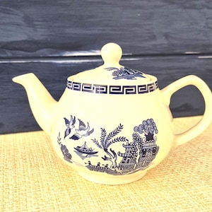 May include: A set of three ceramic nesting bowls in graduating sizes. The bowls are white with a speckled, textured finish and feature a slightly flared rim. The largest bowl is approximately 20 cm in diameter.