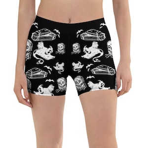 May include: Black athletic shorts with a white print of ghosts, bats, and coffins.
