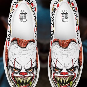 May include: A pair of white slip-on canvas shoes with a graphic print of a scary clown with red hair, a red nose, and a wide, toothy grin. The shoes have black trim and red splatters on the sides. The text "MIDNIGHT MONSTER" is printed on the inside of the shoes.
