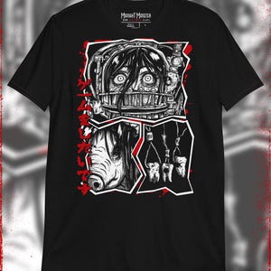 May include: Black t-shirt with a graphic print of a woman's face with a cage over her mouth, a pig's head, and teeth hanging from a rope. The text "Midnight Monster" is printed on the shirt.