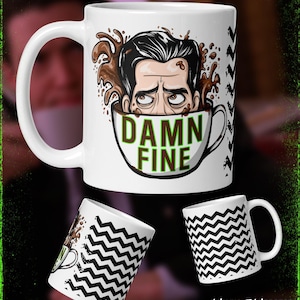 May include: White ceramic coffee mug with a cartoon illustration of a man in a coffee cup, with the words "DAMN FINE". Additional mugs with black and white zig-zag patterns and the text "Midnight Monster" are also shown.