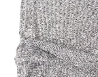 May include: Close-up of a gray and white textured fabric. The fabric has a subtle pattern of small black and white dots.