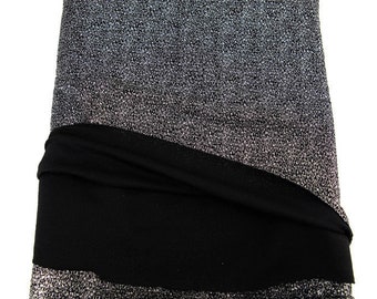 May include: A silver and black fabric with a sparkly texture. The fabric is folded in half and the silver side is facing the camera.