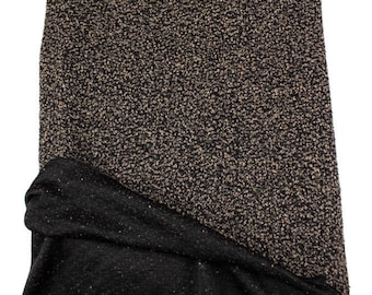 May include: Black and beige textured fabric with a soft, fuzzy feel. The fabric is folded in half, showing both sides.