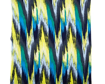May include: Abstract fabric with a colorful pattern of blue, green, yellow, and black stripes. The fabric has a soft, flowing texture.
