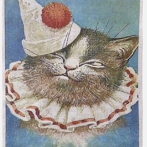 May include: A close-up of a cat wearing a white and red clown hat with a white ruffle collar. The cat has a mischievous expression on its face.