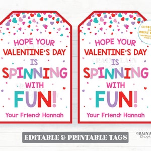 May include: Two printable Valentine's Day gift tags with a red border and a white background. The tags feature a confetti design with pink, red, and blue hearts. The text on the tags reads "Hope your Valentine's Day is spinning with fun!" and "Your Friend: Hannah".