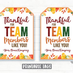 May include: Two printable gift tags with a fall theme. The tags are decorated with orange, yellow, and red leaves. The text on the tags reads "Thankful for Team Members Like You! -Your Name/Company".