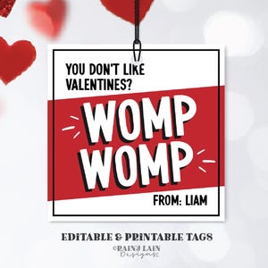 Può includere: Un'etichetta stampabile per San Valentino con sfondo rosso e testo bianco che dice "Non ti piacciono i San Valentino? WOMP WOMP" con spazio per un nome in basso. L'etichetta è modificabile e stampabile.