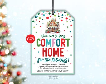 May include: A holiday-themed gift tag with a watercolor illustration of a house and the text "We're here to bring COMFORT HOME for the holidays!". The tag is white with a green border and colorful polka dots.