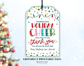May include: A printable gift tag with a colorful design featuring a string of Christmas lights, snowflakes, and the text "Sending some HOLIDAY CHEER your way to say thank you for all you do each day! Merry Christmas! Love, Hannah".