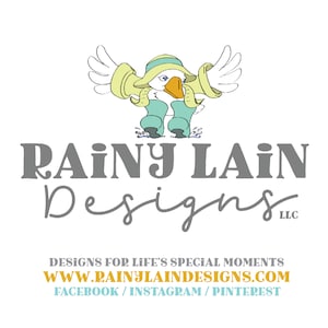 May include: A cartoon illustration of a bird wearing a yellow raincoat and blue rain boots. The text "Rainy Lain Designs LLC" is below the image. The text "Designs for life's special moments" is below the company name. The website address "www.rainylaindesigns.com" is below the text. The text "Facebook / Instagram / Pinterest" is below the website address.