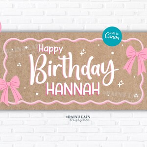 May include: A rectangular banner with a brown background and pink accents. The banner reads "Happy Birthday Hannah" in white script. Pink bows and stars decorate the banner. Pink balloons are in the background.