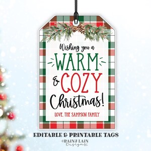 May include: Red and green plaid Christmas gift tag with the text "Wishing you a WARM & COZY Christmas! LOVE. THE SAMPSON FAMILY" and a pine bough with pine cones.