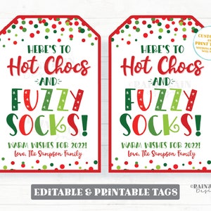 May include: Two printable gift tags with a red and green polka dot background. The tags say "Here's to Hot Chocs and Fuzzy Socks!" with warm wishes for 2022. The tags are editable and printable.