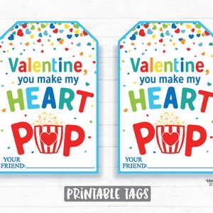 May include: Two printable Valentine's Day gift tags featuring a red and white popcorn bucket with a heart on the side. The text on the tags reads "Valentine, you make my heart pop."