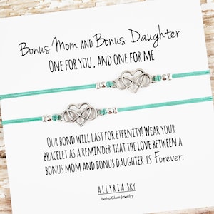 May include: Two turquoise bracelets with silver infinity heart charms and a card that reads "Bonus Mom and Bonus Daughter, One for you, and one for me. Our bond will last for eternity! Wear your bracelet as a reminder that the love between a bonus mom and bonus daughter is forever." The card is signed "Allyria Sky, Boho Glam Jewelry."
