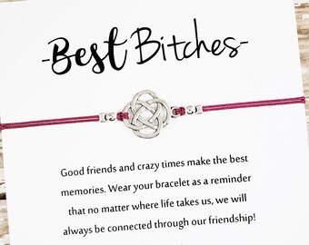 May include: A friendship bracelet with a silver Celtic knot charm and a burgundy cord. The card reads "Best Bitches" and includes a message about friendship. "Good friends and crazy times make the best memories. Wear your bracelet as a reminder that no matter where life takes us, we will always be connected through our friendship!"  ALLYRIA SKY Boho Glam Jewelry