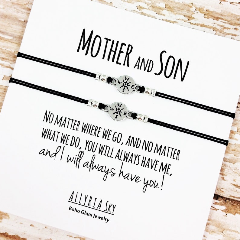 May include: Two black cord bracelets with silver compass charms. The card reads "Mother and Son" and "No matter where we go, and no matter what we do, you will always have me, and I will always have you!"  Allyria Sky Boho Glam Jewelry.