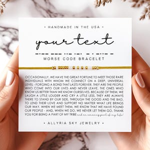May include: A handmade Morse code bracelet with gold beads and a yellow cord. The card behind the bracelet says "your text" and includes a message about friendship. The text also says "Handmade in the USA."
