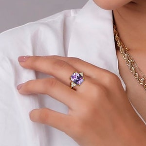 An absolute stunner, classic lavender amethyst engagement ring with an octagon cut gemstone of your choice as it’s centre stone and with round cut clear quartz on the band to further accentuate it.