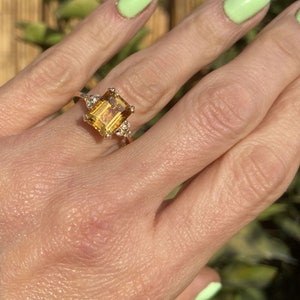 An absolute stunner, classic natural citrine engagement ring with an octagon gemstone of your choice as it’s centre stone and with round cut clear quartz on the band to further accentuate it.