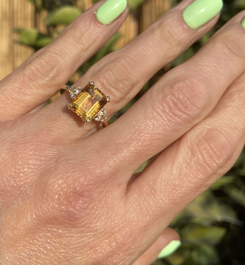 An absolute stunner, classic natural citrine engagement ring with an octagon gemstone of your choice as it’s centre stone and with round cut clear quartz on the band to further accentuate it.