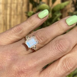 An absolute stunner, classic natural moonstone engagement ring with an octagon cut gemstone of your choice as it’s centre stone and with round cut clear quartz on the band to further accentuate it.