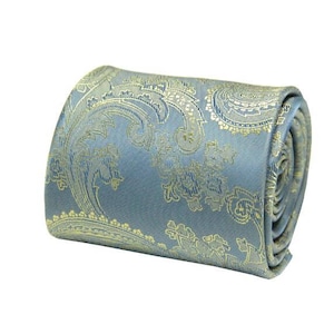 May include: A blue and gold paisley patterned necktie rolled up.