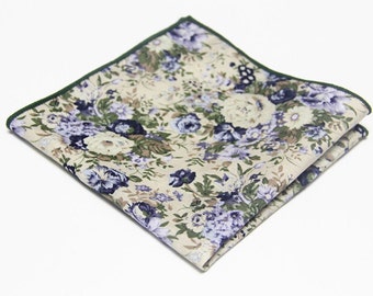 May include: A beige pocket square with a green border and a floral pattern in shades of purple and green.