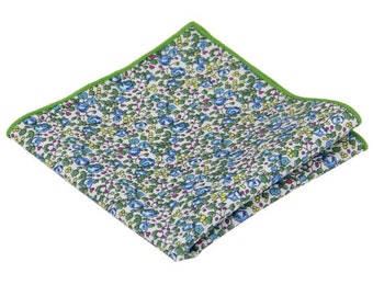 May include: A white pocket square with a green border and a floral pattern featuring blue, pink, and yellow flowers.